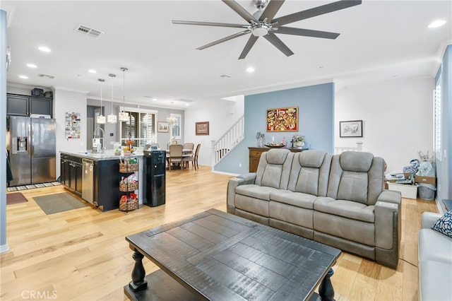 22124 Barrington Way, Saugus, CA 91350 - living room with recessed lighting, a ceiling fan, light wood-style floors, stairway, and crown molding