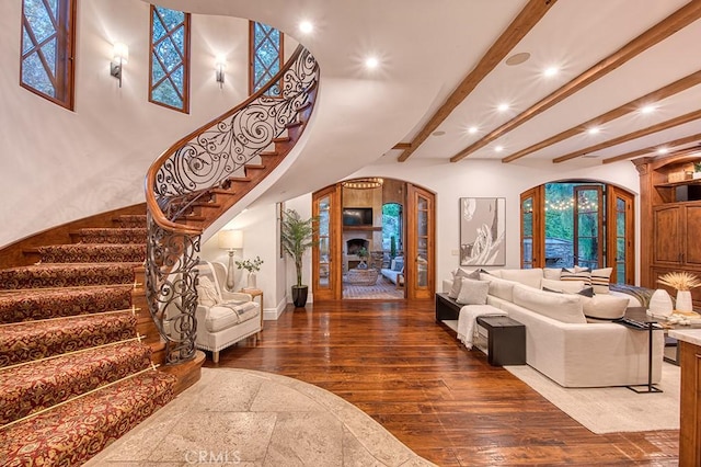 31742 Contijo Way, Coto De Caza, CA 92679 - living room with arched walkways, recessed lighting, stairs, wood finished floors, and beamed ceiling
