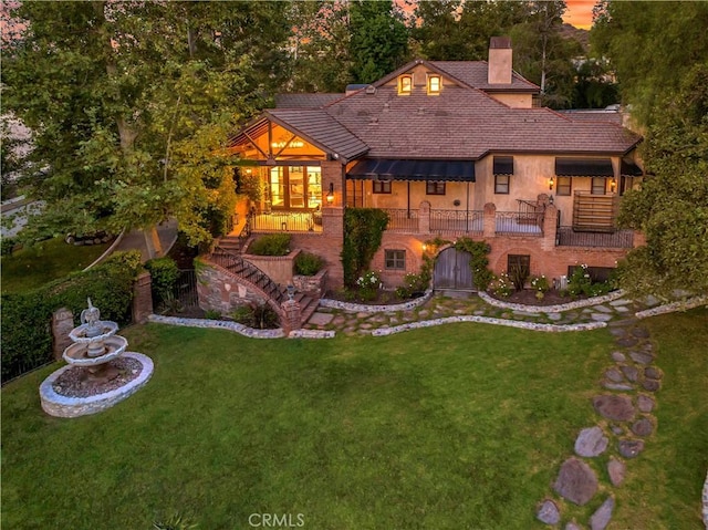 31742 Contijo Way, Coto De Caza, CA 92679 - view of front of home with a front lawn, a chimney, stairway, and stucco siding