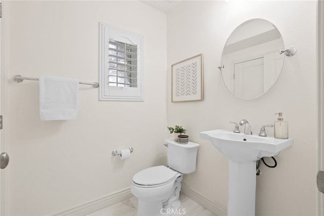 84 Plum Feather, Irvine, CA 92620 - half bath with baseboards, toilet, and marble look tiles