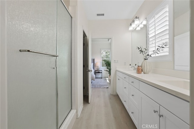 84 Plum Feather, Irvine, CA 92620 - full bathroom featuring wood finished floors, double vanity, a stall shower, and ensuite bath