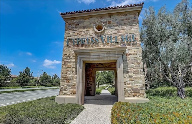 84 Plum Feather, Irvine, CA 92620 - doorway to property featuring stone siding and a tile roof