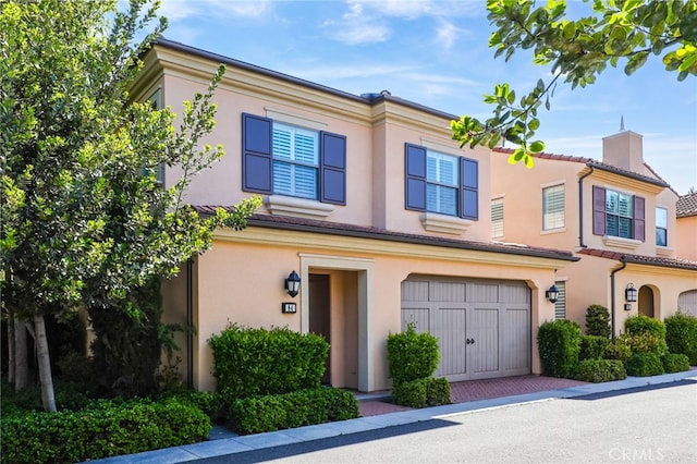 84 Plum Feather, Irvine, CA 92620 - townhome / multi-family property with a chimney, a garage, and stucco siding