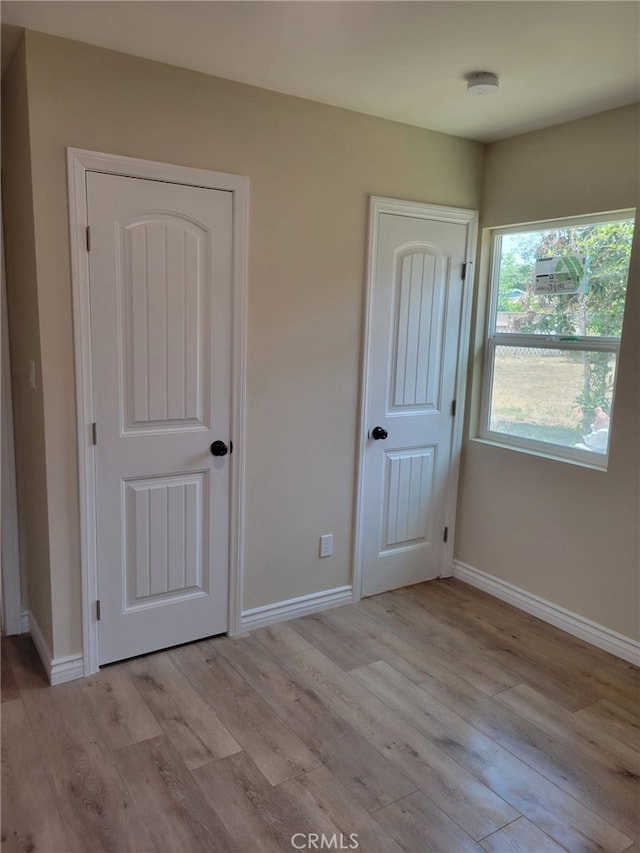 12055 Mount Vernon Ave, Grand Terrace, CA 92313 - unfurnished bedroom featuring light wood-style floors and baseboards