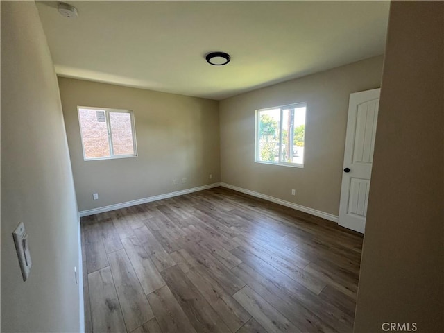 12055 Mount Vernon Ave, Grand Terrace, CA 92313 - spare room featuring plenty of natural light, wood finished floors, a smoke detector, and baseboards