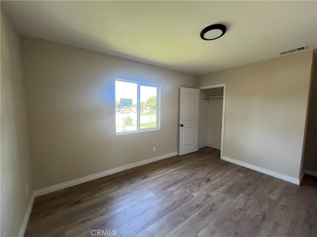 12055 Mount Vernon Ave, Grand Terrace, CA 92313 - unfurnished bedroom with wood finished floors, baseboards, and a closet