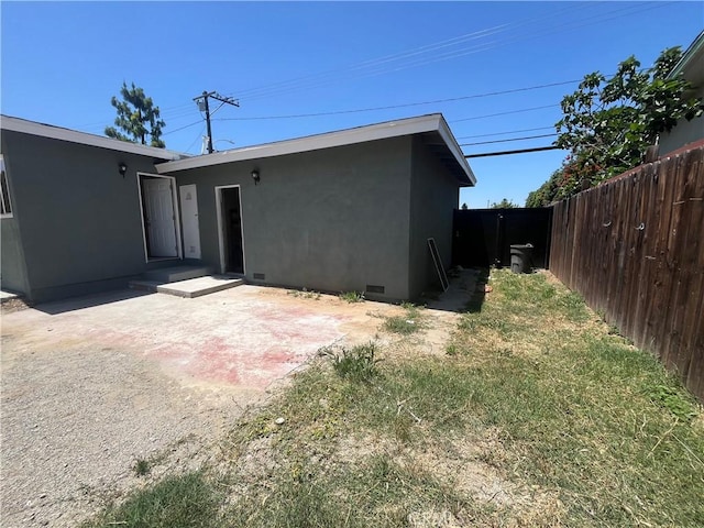 12055 Mount Vernon Ave, Grand Terrace, CA 92313 - back of property with stucco siding, a patio area, and crawl space