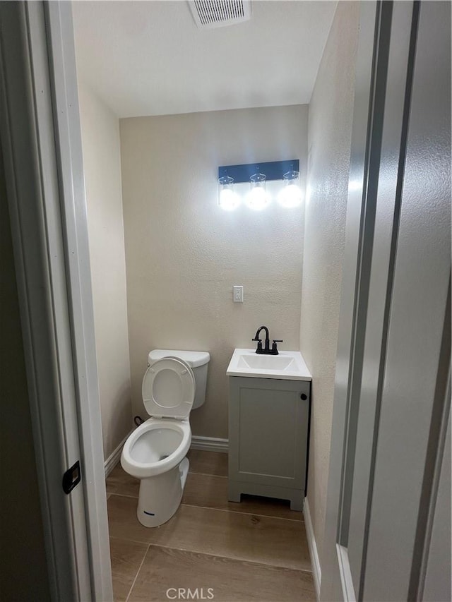 12055 Mount Vernon Ave, Grand Terrace, CA 92313 - bathroom with toilet, baseboards, and vanity
