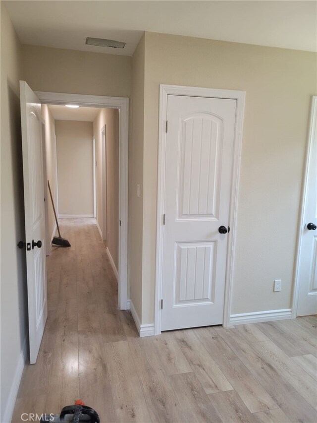 12055 Mount Vernon Ave, Grand Terrace, CA 92313 - hallway featuring light wood-style flooring and baseboards