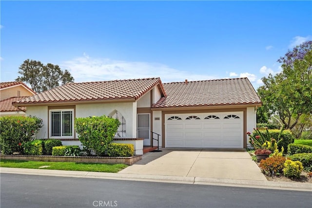 28052 Espinoza, Mission Viejo, CA 92692 - view of front of home with an attached garage, driveway, stucco siding, and a tile roof