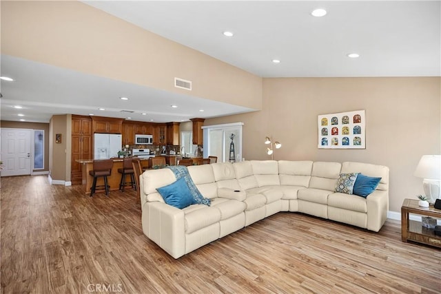 28052 Espinoza, Mission Viejo, CA 92692 - living area with light wood-type flooring, recessed lighting, baseboards, and lofted ceiling