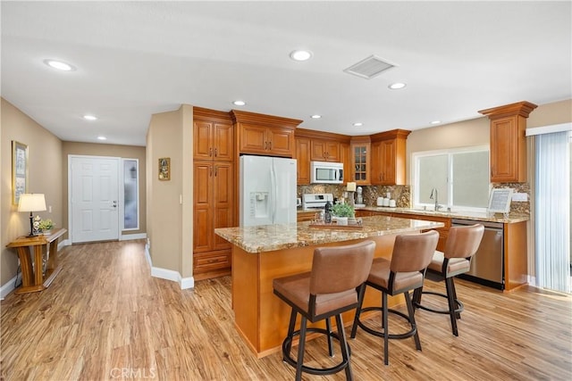 28052 Espinoza, Mission Viejo, CA 92692 - kitchen with stainless steel appliances, brown cabinets, decorative backsplash, and recessed lighting