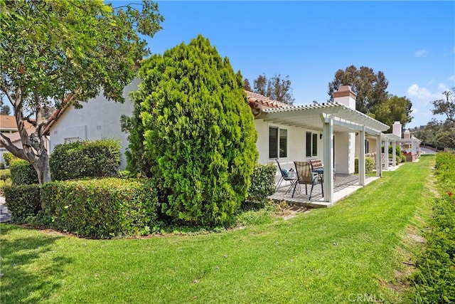 28052 Espinoza, Mission Viejo, CA 92692 - back of house with a pergola, a yard, a chimney, stucco siding, and a patio