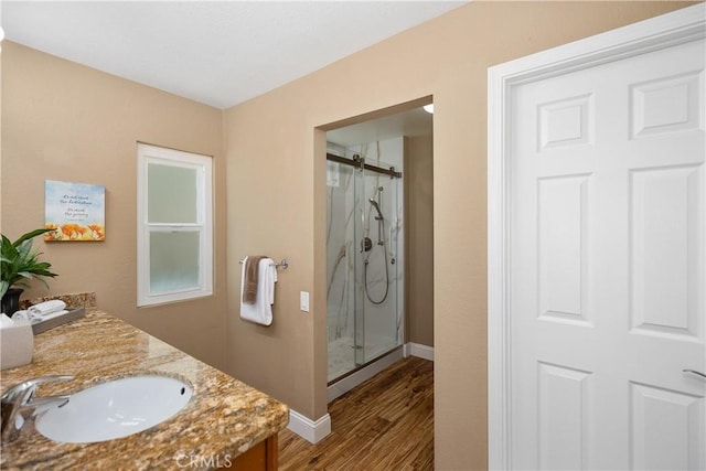 28052 Espinoza, Mission Viejo, CA 92692 - bathroom featuring a shower stall, wood finished floors, baseboards, and double vanity