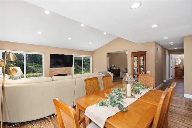 28052 Espinoza, Mission Viejo, CA 92692 - dining space with light wood-style flooring, lofted ceiling, recessed lighting, a fireplace, and baseboards