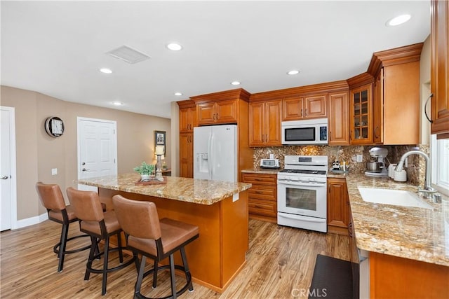 28052 Espinoza, Mission Viejo, CA 92692 - kitchen featuring white appliances, a sink, brown cabinets, light wood-style floors, and recessed lighting