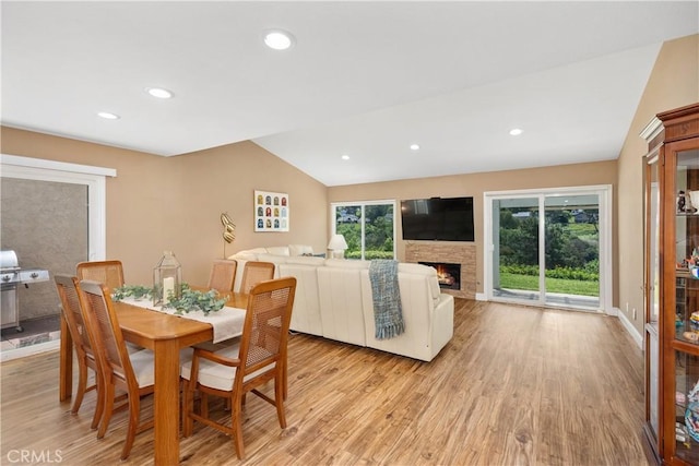 28052 Espinoza, Mission Viejo, CA 92692 - dining space with vaulted ceiling, light wood-type flooring, a stone fireplace, recessed lighting, and baseboards