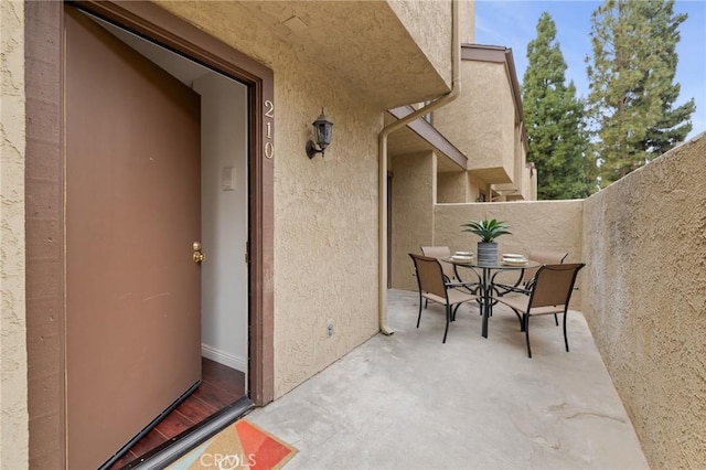 849 E Victoria St Unit 210, Carson, CA 90746 - property entrance featuring stucco siding, a patio area, and outdoor dining area
