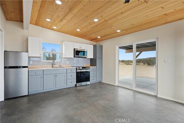 57628 Pine St, Landers, CA 92285 - kitchen with stainless steel appliances, wooden ceiling, recessed lighting, finished concrete floors, and decorative backsplash