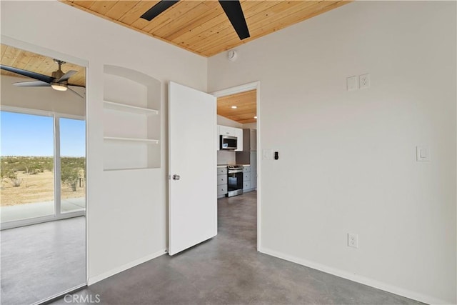 57628 Pine St, Landers, CA 92285 - empty room with wooden ceiling, ceiling fan, concrete flooring, baseboards, and built in shelves