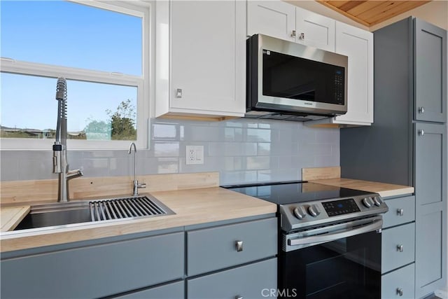 57628 Pine St, Landers, CA 92285 - kitchen with stainless steel appliances, a sink, light countertops, and tasteful backsplash