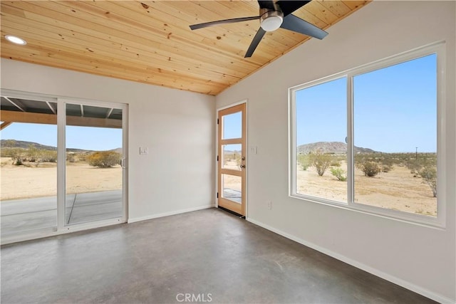 57628 Pine St, Landers, CA 92285 - empty room with wood ceiling, a mountain view, baseboards, concrete floors, and a ceiling fan