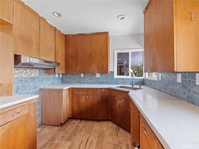 31611 157th St E, Llano, CA 93544 - kitchen featuring under cabinet range hood, a sink, light wood finished floors, and decorative backsplash