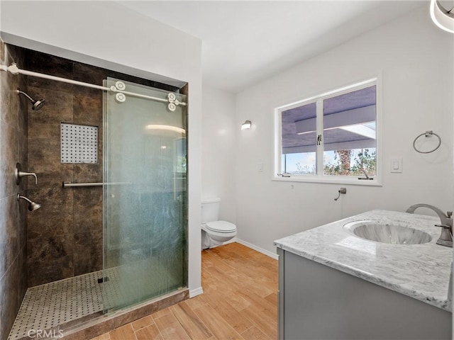 31611 157th St E, Llano, CA 93544 - full bathroom with a tile shower, toilet, vanity, wood finished floors, and baseboards