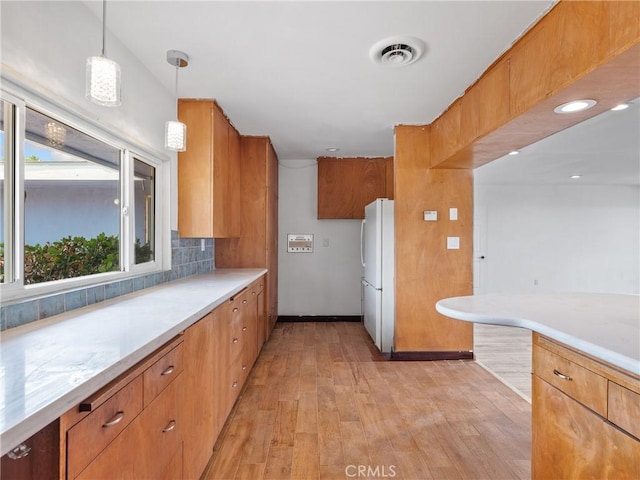 31611 157th St E, Llano, CA 93544 - kitchen with freestanding refrigerator, light wood-style flooring, light countertops, and tasteful backsplash