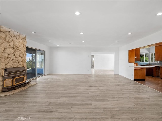 31611 157th St E, Llano, CA 93544 - unfurnished living room featuring a wood stove, light wood-type flooring, and recessed lighting