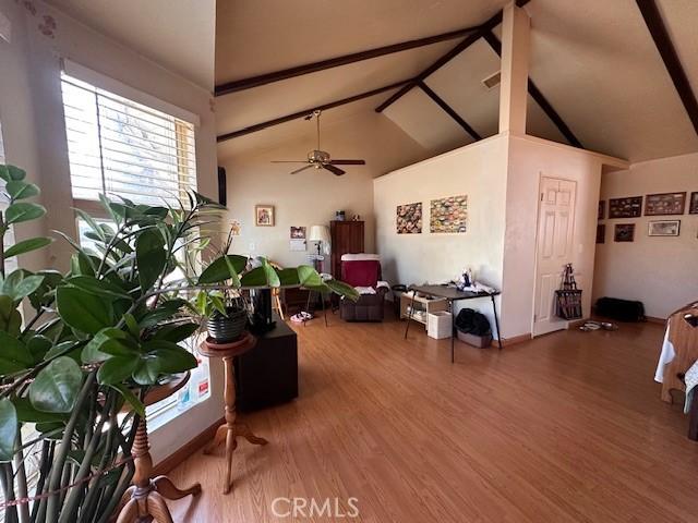 2968 Mill Creek Rd, Mentone, CA 92359 - living area featuring ceiling fan, wood finished floors, beamed ceiling, and high vaulted ceiling