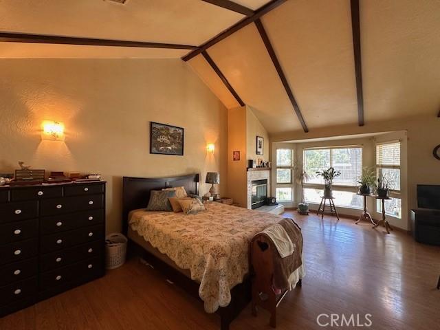 2968 Mill Creek Rd, Mentone, CA 92359 - bedroom with wood finished floors and a fireplace
