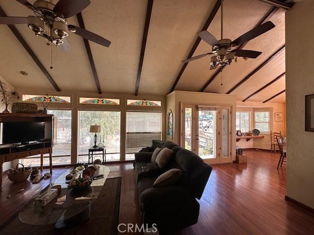2968 Mill Creek Rd, Mentone, CA 92359 - living area featuring beamed ceiling, ceiling fan, wood finished floors, and high vaulted ceiling
