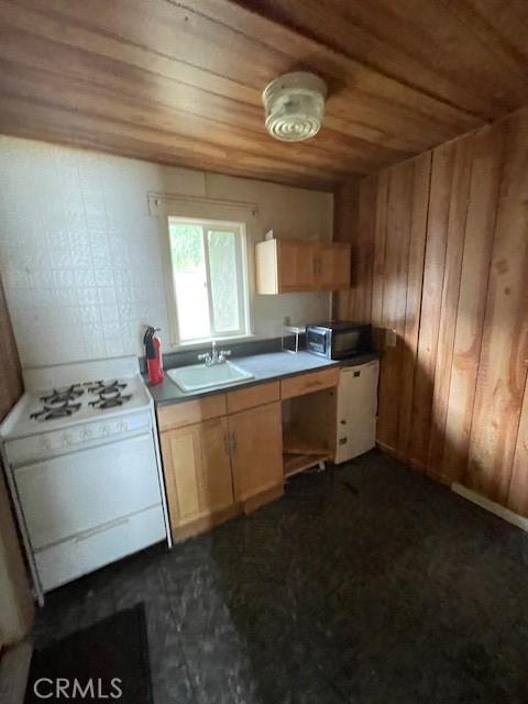2968 Mill Creek Rd, Mentone, CA 92359 - kitchen featuring a sink, wood ceiling, white gas stove, and wooden walls