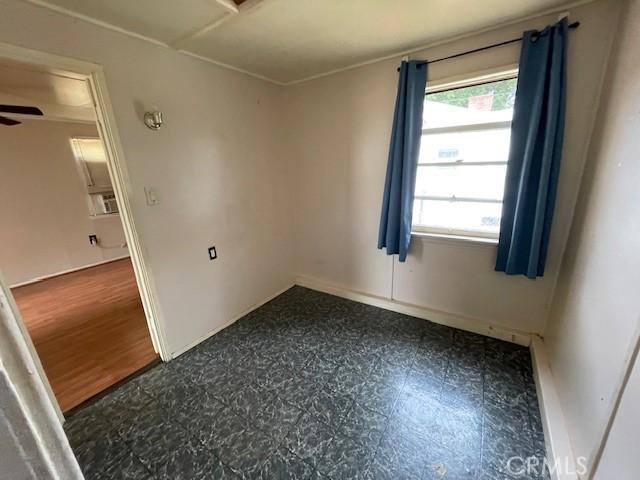 2968 Mill Creek Rd, Mentone, CA 92359 - spare room featuring baseboards, a ceiling fan, and dark flooring