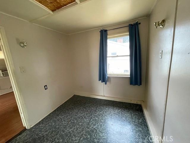 2968 Mill Creek Rd, Mentone, CA 92359 - empty room featuring baseboards and dark flooring