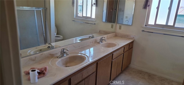56994 Crestview Dr, Yucca Valley, CA 92284 - bathroom featuring double vanity, toilet, baseboards, a shower with door, and tile patterned floors