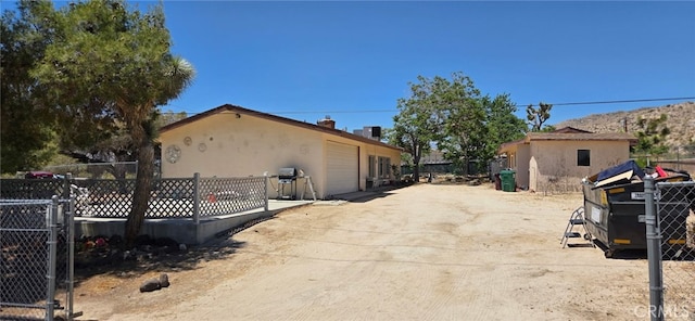 56994 Crestview Dr, Yucca Valley, CA 92284 - view of side of home with a garage