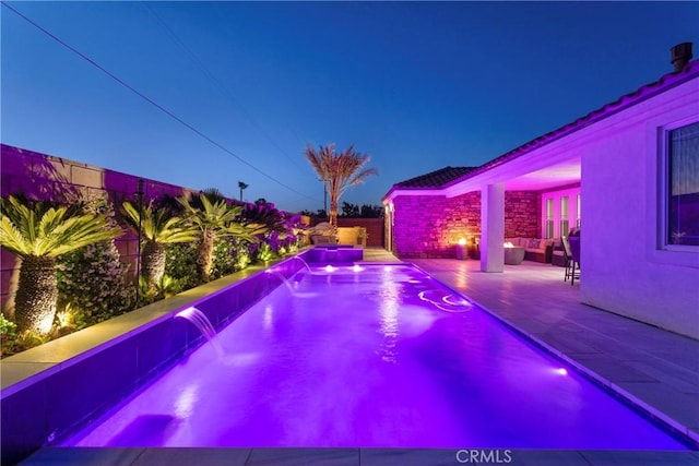 14258 Crow Rd, Apple Valley, CA 92307 - pool at night with an outdoor hangout area, a pool with connected hot tub, and a patio area