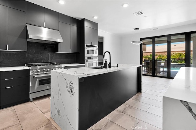 14258 Crow Rd, Apple Valley, CA 92307 - kitchen with stainless steel appliances, range hood, dark cabinets, tasteful backsplash, and recessed lighting