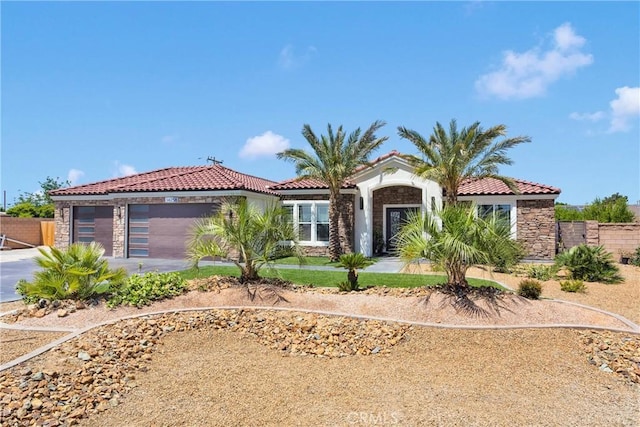 14258 Crow Rd, Apple Valley, CA 92307 - mediterranean / spanish home with a tiled roof, a garage, driveway, and stone siding