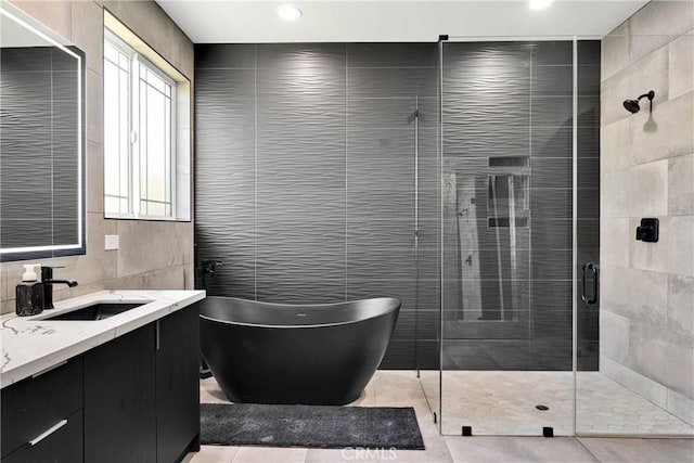 14258 Crow Rd, Apple Valley, CA 92307 - full bathroom with tile walls, a soaking tub, a stall shower, vanity, and recessed lighting