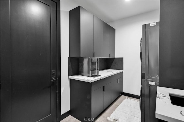 14258 Crow Rd, Apple Valley, CA 92307 - kitchen with gray cabinets, light stone counters, and baseboards
