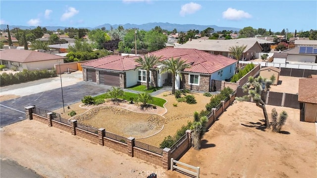 14258 Crow Rd, Apple Valley, CA 92307 - mediterranean / spanish home featuring asphalt driveway, a residential view, an attached garage, and a tiled roof