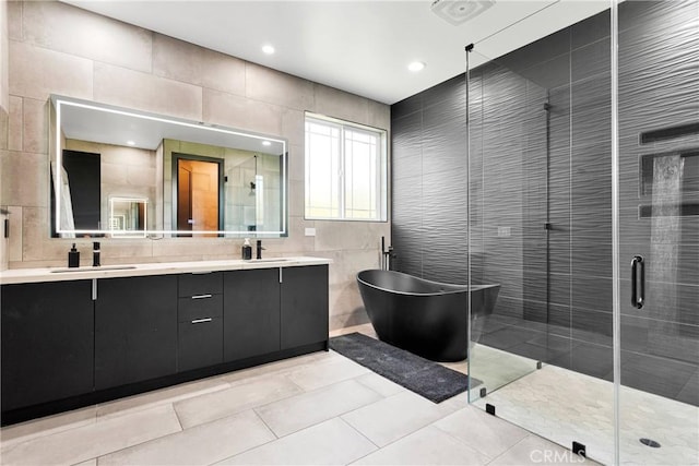 14258 Crow Rd, Apple Valley, CA 92307 - bathroom featuring tile walls, a freestanding tub, double vanity, a stall shower, and tile patterned floors