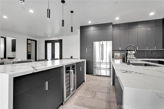 14258 Crow Rd, Apple Valley, CA 92307 - kitchen with high quality fridge, a large island, open floor plan, dark cabinetry, and ornamental molding