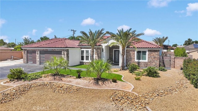 14258 Crow Rd, Apple Valley, CA 92307 - view of front of home with stone siding, a tile roof, concrete driveway, and an attached garage