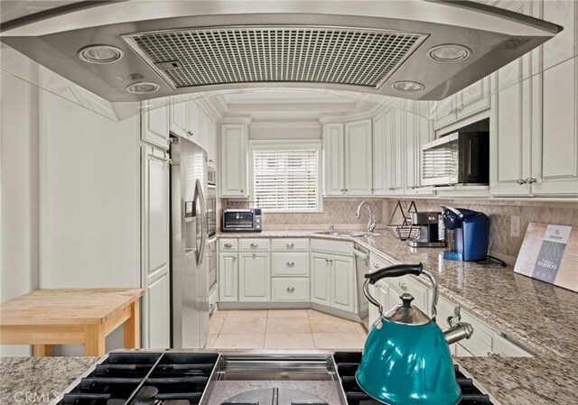 1126 W 13th St Unit 1, San Pedro, CA 90731 - kitchen with a sink, appliances with stainless steel finishes, range hood, light stone counters, and white cabinetry