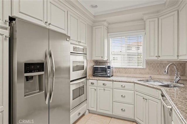 1126 W 13th St Unit 1, San Pedro, CA 90731 - kitchen featuring stainless steel appliances, a sink, white cabinetry, ornamental molding, and tasteful backsplash