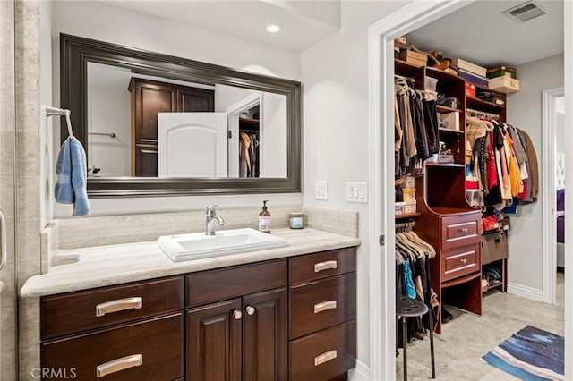 1126 W 13th St Unit 1, San Pedro, CA 90731 - bathroom featuring vanity, a walk in closet, and baseboards